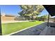 Landscaped backyard features artificial turf, gravel, and mature trees, creating a serene and inviting outdoor space at 14017 N 40Th Ave, Phoenix, AZ 85053