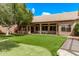 Beautiful backyard featuring artificial turf, a covered patio, and lush landscaping at 1777 W Redfield Rd, Gilbert, AZ 85233