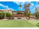 Backyard featuring a pergola with a fire pit, artificial turf and desert landscaping at 1777 W Redfield Rd, Gilbert, AZ 85233