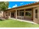 Covered patio and backyard with artificial turf and dining table, perfect for outdoor living at 1777 W Redfield Rd, Gilbert, AZ 85233