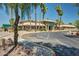 Community clubhouse is surrounded by palm trees and manicured greenery at 1777 W Redfield Rd, Gilbert, AZ 85233