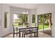 Bright dining room boasts backyard views, wood floors, and modern lighting at 1777 W Redfield Rd, Gilbert, AZ 85233