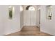 Bright entryway featuring wood flooring, an arched doorway, and decorative niches at 1777 W Redfield Rd, Gilbert, AZ 85233