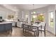 Eat-in kitchen features white cabinets, stainless appliances, and view to outdoor pergola at 1777 W Redfield Rd, Gilbert, AZ 85233