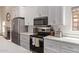 Kitchen features stainless steel oven, range, and microwave, with white cabinets at 1777 W Redfield Rd, Gilbert, AZ 85233