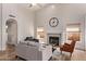 Modern living room with fireplace, vaulted ceiling, wood floors, and neutral tones at 1777 W Redfield Rd, Gilbert, AZ 85233