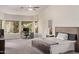 Bright main bedroom with many windows, desk, and en-suite bathroom at 1777 W Redfield Rd, Gilbert, AZ 85233