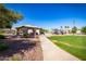 Community park featuring a covered picnic area, playground, and walking path under a blue sky at 1777 W Redfield Rd, Gilbert, AZ 85233