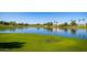 Beautiful pond reflecting nearby houses and palm trees in a well-maintained community at 1777 W Redfield Rd, Gilbert, AZ 85233