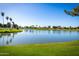 Calm pond with green banks and clear reflections, enhancing the community's natural beauty at 1777 W Redfield Rd, Gilbert, AZ 85233
