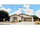 Charming single-story home with a well-manicured lawn and attached two-car garage at 2487 E Aris Dr, Gilbert, AZ 85298
