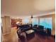 Spacious living room featuring dark wood floors, recessed lighting, and large bright windows at 2487 E Aris Dr, Gilbert, AZ 85298