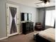 The main bedroom features a TV, door access, and a cozy chair for a relaxing retreat at 2487 E Aris Dr, Gilbert, AZ 85298