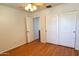 Bright bedroom showcasing wood-look floors, a ceiling fan, and a closet with paneled doors at 2873 S Arroyo Ln, Gilbert, AZ 85295