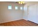 Bedroom with laminate flooring, three small windows, a ceiling fan and a closet with sliding doors at 2873 S Arroyo Ln, Gilbert, AZ 85295