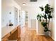 Hallway with laminate flooring and bright white walls, and a glimpse of the decor in a room at 2873 S Arroyo Ln, Gilbert, AZ 85295