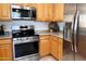 Modern kitchen featuring stainless steel appliances and light wood cabinetry at 2873 S Arroyo Ln, Gilbert, AZ 85295