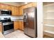 Kitchen featuring stainless steel appliances, light wood cabinets, and tile flooring for a sleek design at 2873 S Arroyo Ln, Gilbert, AZ 85295