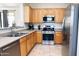 Well-lit kitchen featuring stainless steel appliances and light wood cabinetry at 2873 S Arroyo Ln, Gilbert, AZ 85295