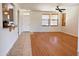 Bright living room featuring wood floors, a ceiling fan, and natural light from two windows at 2873 S Arroyo Ln, Gilbert, AZ 85295