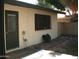 Rear exterior view of home featuring door, window, and rock landscaping at 4718 W El Caminito Dr, Glendale, AZ 85302