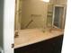Bathroom featuring double sinks, large vanity, and handicap safety bar at 4718 W El Caminito Dr, Glendale, AZ 85302