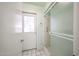 Bathroom with shower and door leading to the outside at 4718 W El Caminito Dr, Glendale, AZ 85302