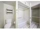 Functional bathroom featuring a toilet, built-in shelves and a shower-tub combo at 4718 W El Caminito Dr, Glendale, AZ 85302