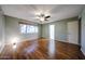 Spacious bedroom with hardwood floors, neutral walls, and a ceiling fan for comfort at 4718 W El Caminito Dr, Glendale, AZ 85302
