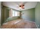 Bedroom featuring carpeting, a ceiling fan and a window with shutters at 4718 W El Caminito Dr, Glendale, AZ 85302