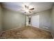 Bedroom featuring carpeting, a ceiling fan, and convenient closet space at 4718 W El Caminito Dr, Glendale, AZ 85302