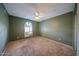 Bedroom featuring carpeted floors, a ceiling fan and window with shutters at 4718 W El Caminito Dr, Glendale, AZ 85302
