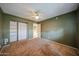Bedroom featuring carpeted floors, a ceiling fan, and closet with shelving at 4718 W El Caminito Dr, Glendale, AZ 85302