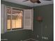 Well-lit bedroom with shuttered window and ceiling fan at 4718 W El Caminito Dr, Glendale, AZ 85302