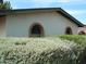 Exterior home view with brick arch windows and xeriscaping, enhancing its southwestern charm at 4718 W El Caminito Dr, Glendale, AZ 85302
