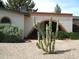 Southwestern home exterior with desert landscaping, including unique cactus and brick accents at 4718 W El Caminito Dr, Glendale, AZ 85302