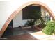 Charming front entrance with a brick archway and lush landscaping, creating a welcoming curb appeal at 4718 W El Caminito Dr, Glendale, AZ 85302