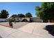 Attractive single-story home boasting desert landscaping, a brick archway, and a large driveway at 4718 W El Caminito Dr, Glendale, AZ 85302