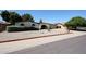 Inviting single-story home featuring desert landscaping, a unique brick archway, and an attached garage at 4718 W El Caminito Dr, Glendale, AZ 85302