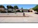 Charming single-story home with desert landscaping, a brick archway, and a two-car garage at 4718 W El Caminito Dr, Glendale, AZ 85302