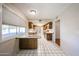 Kitchen with white tile and wooden cabinetry and bar seating at 4718 W El Caminito Dr, Glendale, AZ 85302