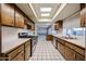 Bright kitchen with a gas range stove, white countertops, tile flooring, and wooden cabinetry at 4718 W El Caminito Dr, Glendale, AZ 85302