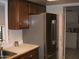 Kitchen showcasing stainless steel refrigerator and a view into the laundry room at 4718 W El Caminito Dr, Glendale, AZ 85302