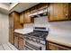 Functional kitchen with stainless steel appliances, a gas range, and wood cabinets at 4718 W El Caminito Dr, Glendale, AZ 85302