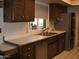 Kitchen featuring dark cabinetry, stainless steel appliances, and ample counter space at 4718 W El Caminito Dr, Glendale, AZ 85302