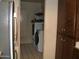 Small laundry room with stacked washer and dryer; cabinets offer storage space at 4718 W El Caminito Dr, Glendale, AZ 85302