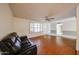 Inviting living room featuring hardwood floors, neutral walls, plantation shutters and a ceiling fan at 4718 W El Caminito Dr, Glendale, AZ 85302