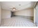 Open living room with tiled flooring and access to the patio at 4718 W El Caminito Dr, Glendale, AZ 85302