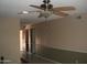 Open living room with ceiling fan and neutral color scheme at 4718 W El Caminito Dr, Glendale, AZ 85302