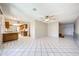 View of living room with white tile floors that leads to kitchen at 4718 W El Caminito Dr, Glendale, AZ 85302